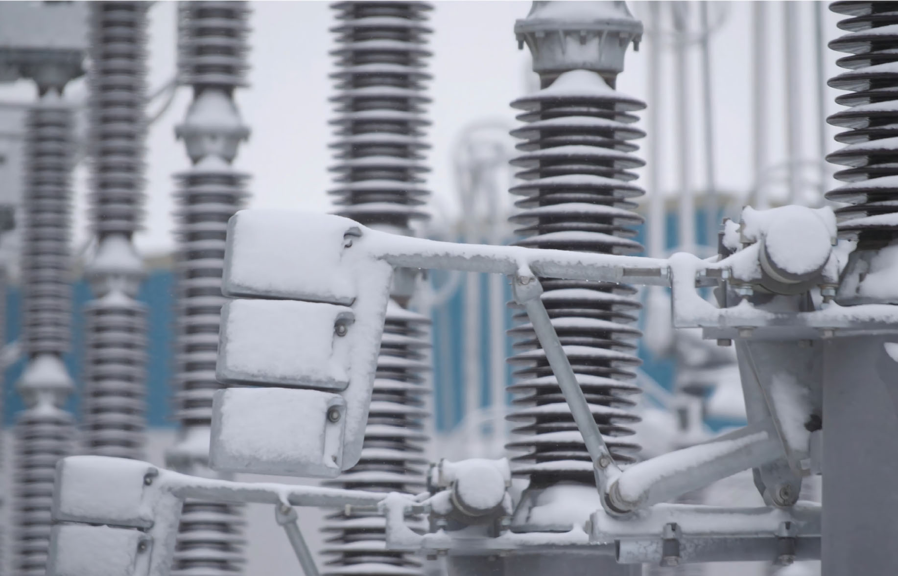 Snow-covered high-voltage substation equipment